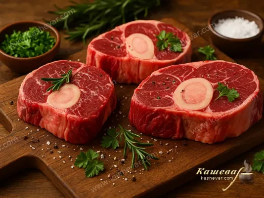 Raw beef cuts with bone and herbs on a cutting board