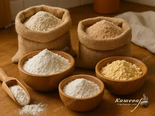 Different types of flour in bags and wooden bowls