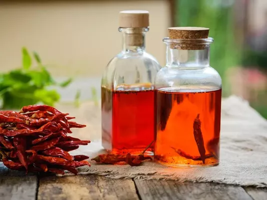 Aromatic oil with hot chili peppers in a glass bottle