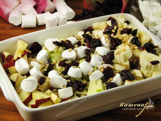 Apples and bananas mixed with cranberries and marshmallows