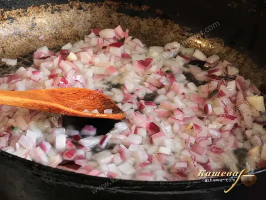 Finely chopped onion in a frying pan
