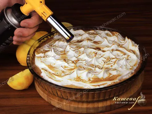 Meringue baking on lemon pie