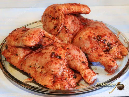 Chicken halves smeared with spices