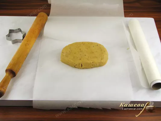 Roll out the dough on a paper spread surface
