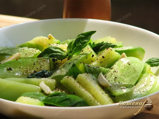 Mixing zucchini salad ingredients