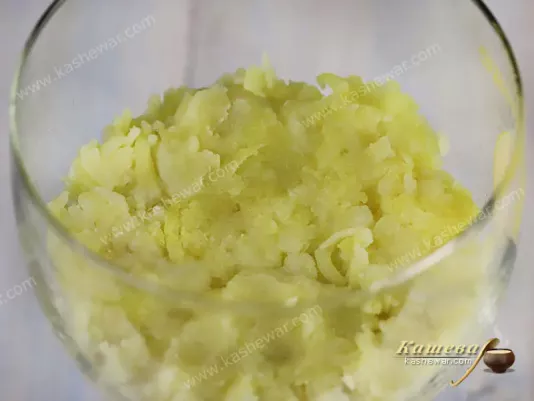 Grated boiled potatoes in a glass