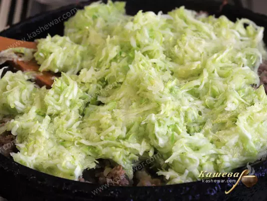 Grated zucchini in a pan