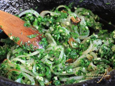 Greens and onions in a pan