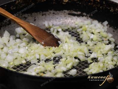 Мелко порезанный лук на сковороде с оливковым маслом