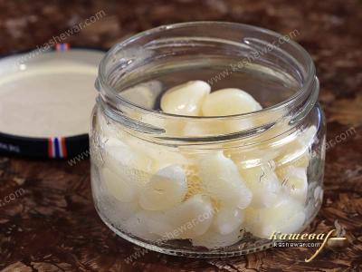 Peeled garlic in a glass jar for canning