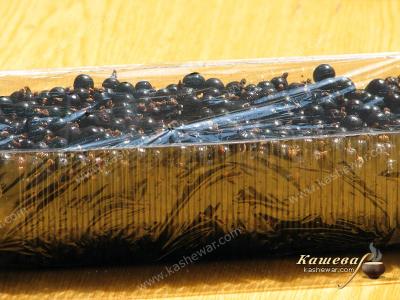 Black currant in a freezer container
