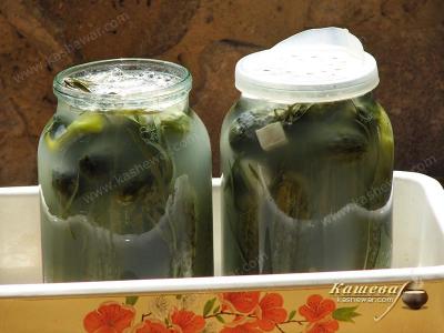 Draining the brine from salted cucumbers